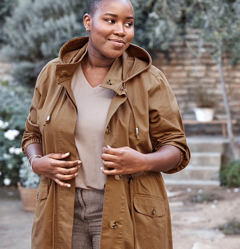 Women wearing a brown coat.