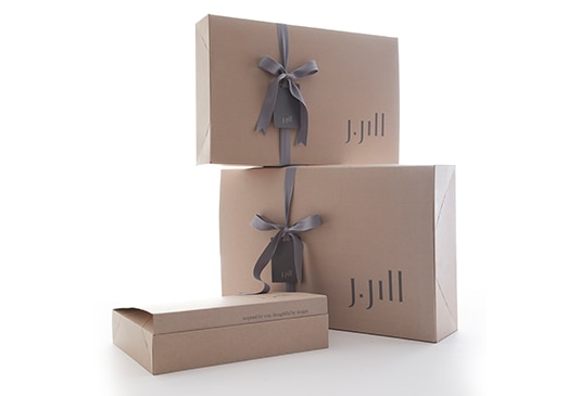 Gift box with a beige color and a grey J.Jill logo and grey ribbon