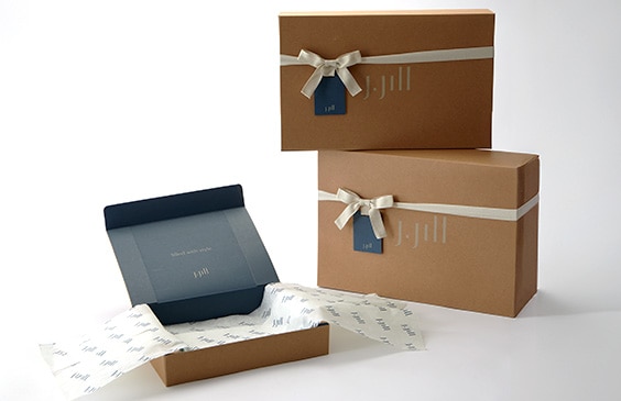 Gift box with a beige color and a grey J.Jill logo and grey ribbon